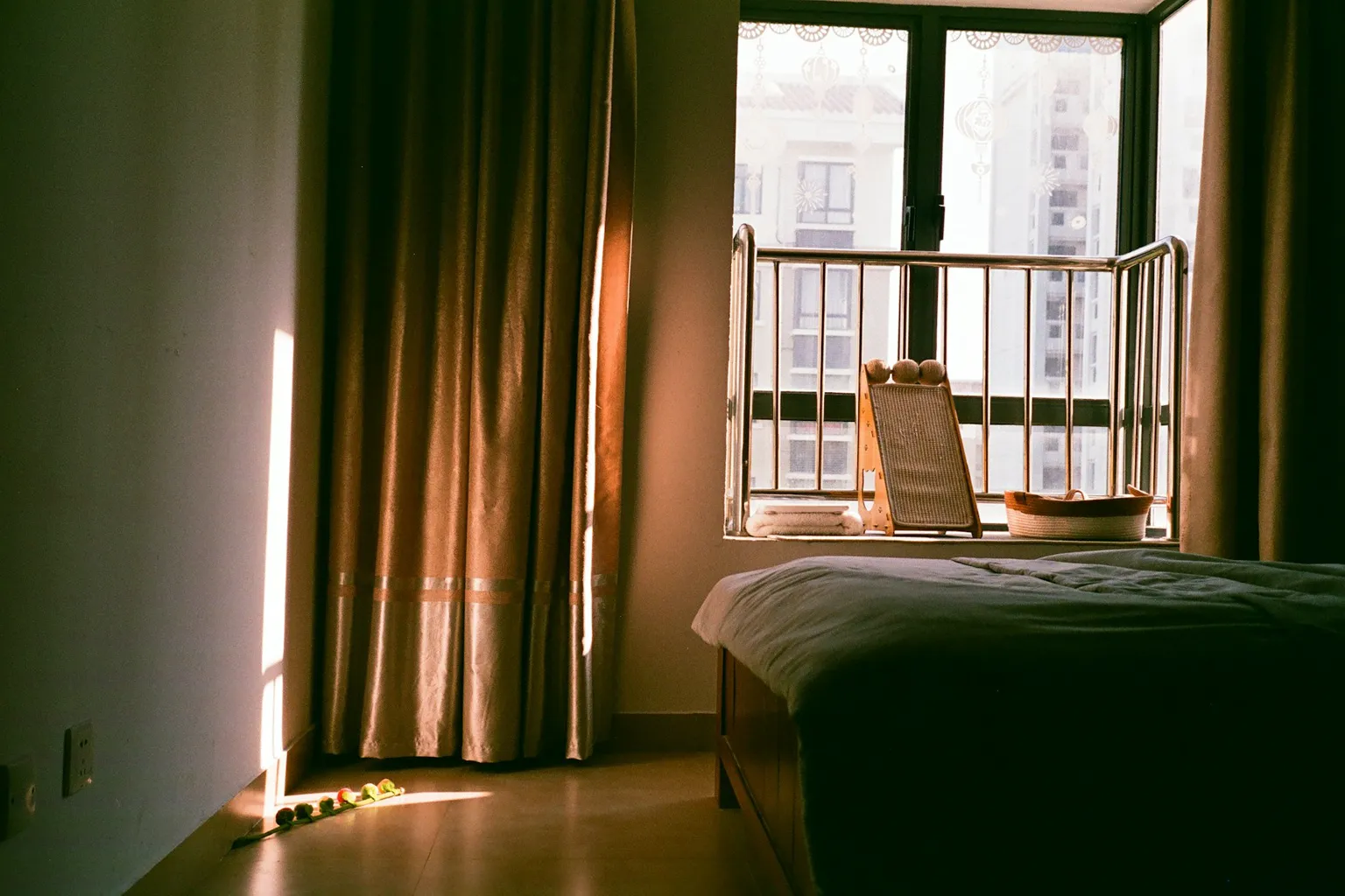 Afternoon sun on a window with blackout curtains partly drawn